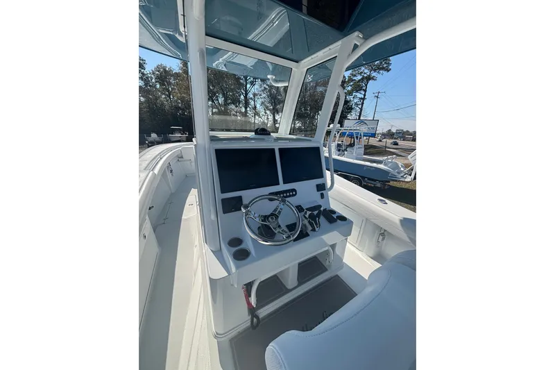  Yacht Photos Pics 2026 Yellowfin 36 Offshore boat cockpit with modern steering and navigation system.