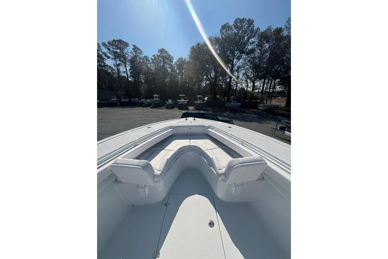  Yacht Photos Pics 2026 Yellowfin 36 Offshore boat with spacious seating, parked outdoors under clear sky.