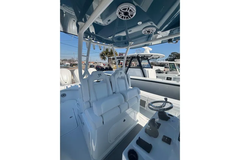  Yacht Photos Pics 2026 Yellowfin 36 Offshore boat interior with helm, seating, and speakers.