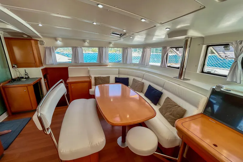 Sailifi Yacht Photos Pics Luxurious interior of a 2007 Lagoon 440 catamaran with elegant seating and dining area.
