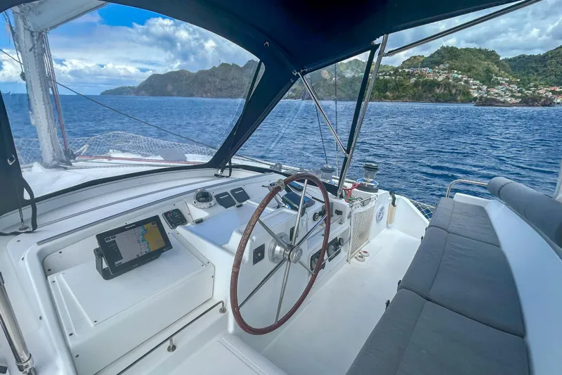 Sailifi Yacht Photos Pics Helm of 2007 Lagoon 440 catamaran with scenic ocean and island view.
