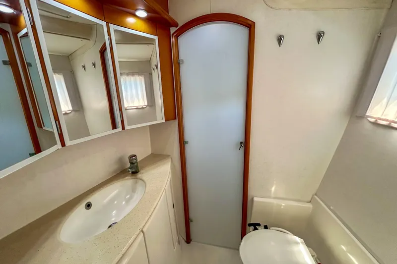 Sailifi Yacht Photos Pics Bathroom interior of 2007 Lagoon 440 yacht with sink, mirror, and shower.