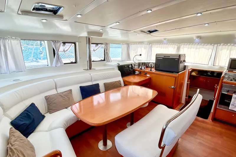 Sailifi Yacht Photos Pics Luxurious interior of 2007 Lagoon 440 catamaran with spacious seating and modern amenities.