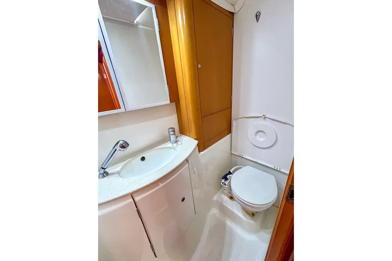 Sailifi Yacht Photos Pics Compact bathroom in 2007 Lagoon 440 yacht with sink, mirror, and toilet.