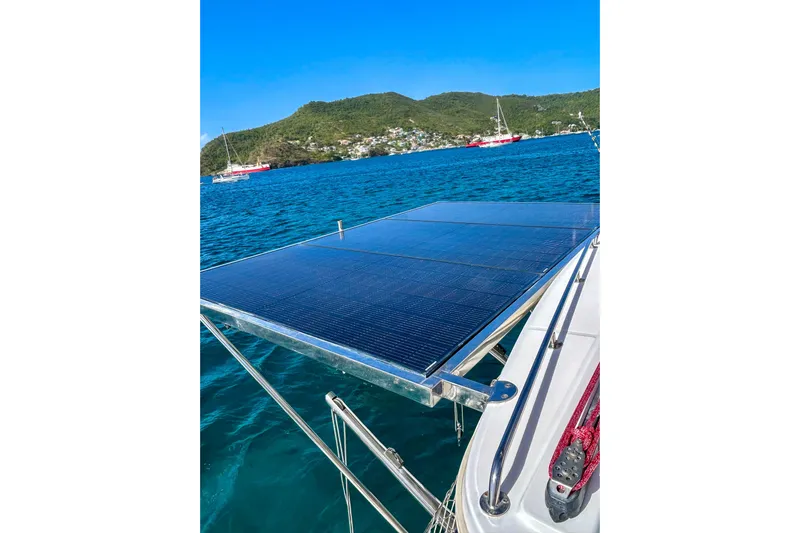Sailifi Yacht Photos Pics Solar panels on a 2007 Lagoon 440 catamaran, anchored in a scenic bay.
