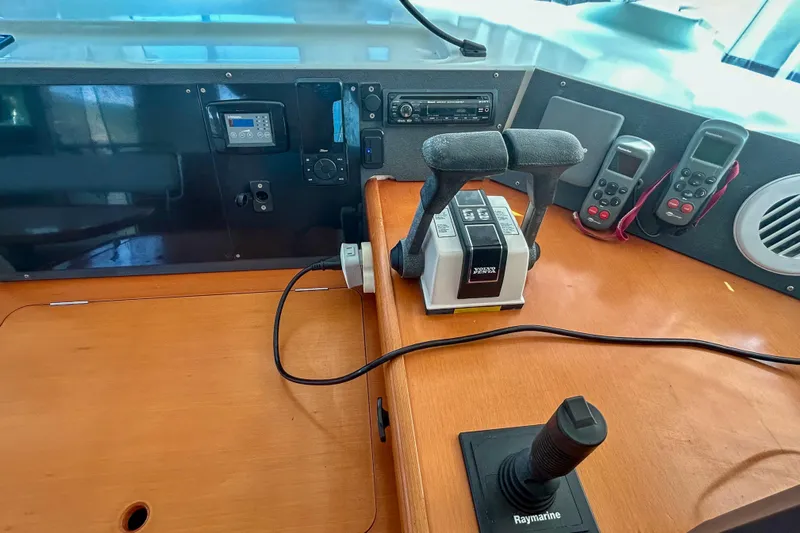 Sailifi Yacht Photos Pics Control panel of a 2007 Lagoon 440 catamaran with navigation equipment and throttle controls.