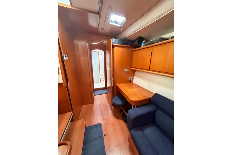 Sailifi Yacht Photos Pics Interior of 2007 Lagoon 440 yacht with wooden cabinetry and blue seating.