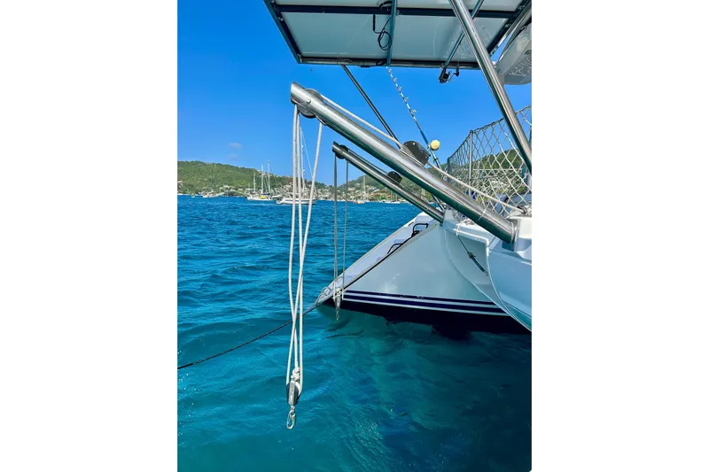 Sailifi Yacht Photos Pics Lagoon 440 catamaran, 2007 model, anchored in clear blue waters with scenic background.