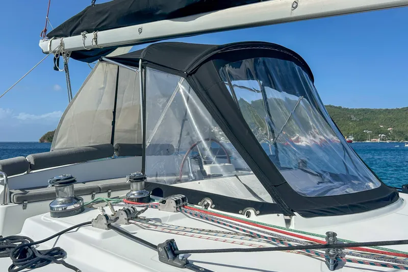 Sailifi Yacht Photos Pics 2007 Lagoon 440 sailboat cockpit with clear canopy, moored in scenic bay.
