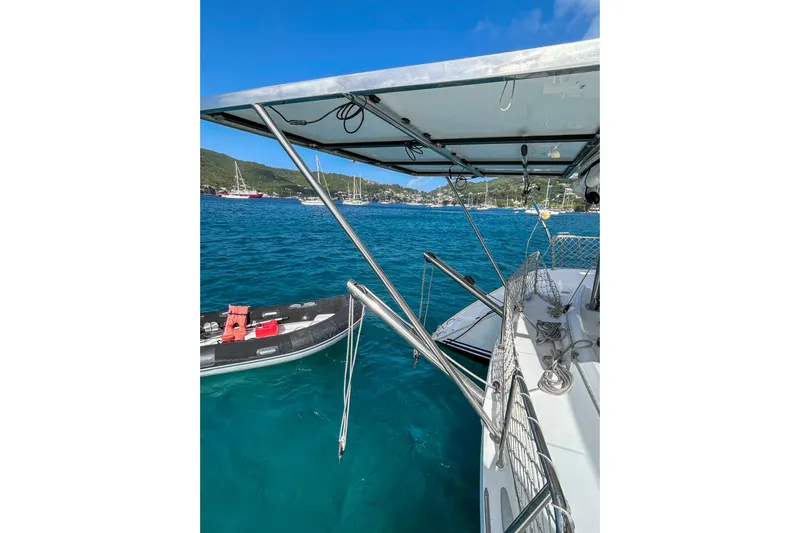 Sailifi Yacht Photos Pics Lagoon 440 catamaran, 2007 model, anchored in a scenic bay with clear blue water.