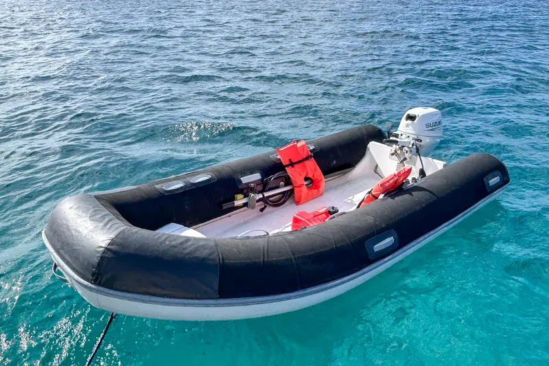 Sailifi Yacht Photos Pics Inflatable boat with Suzuki motor on clear blue water, featuring safety equipment.