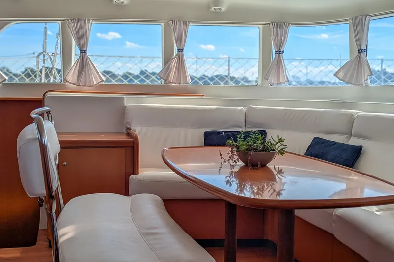 Sailifi Yacht Photos Pics Interior of 2007 Lagoon 440 yacht with elegant seating and table arrangement.