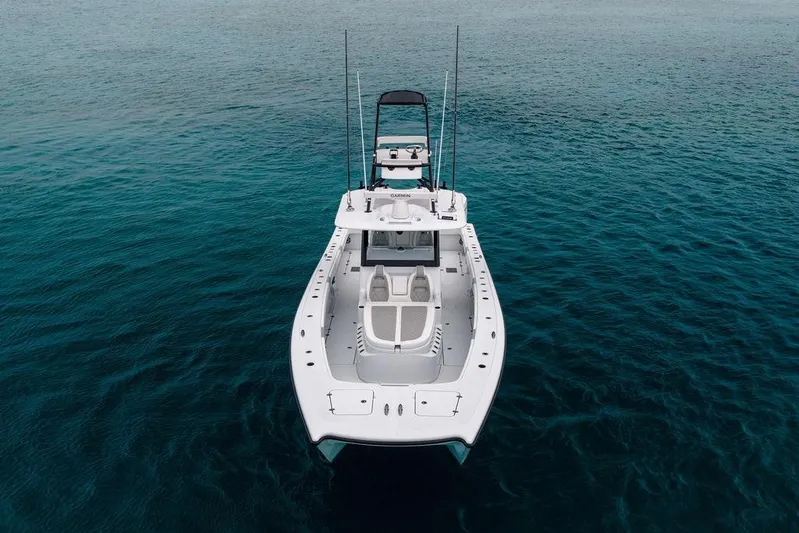 Never Enough Yacht Photos Pics 2025 Freeman 38 boat on clear blue water, aerial view.