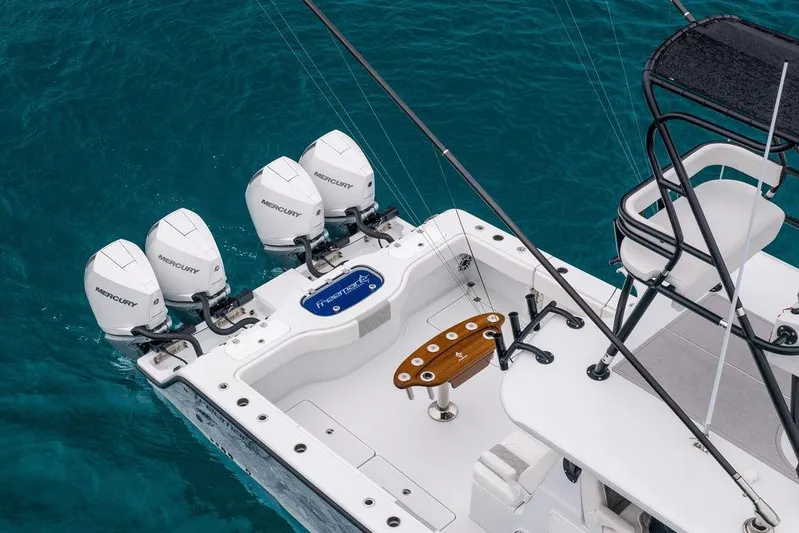 Never Enough Yacht Photos Pics Freeman 38 boat, 2025 model, with four Mercury outboard engines on blue water.