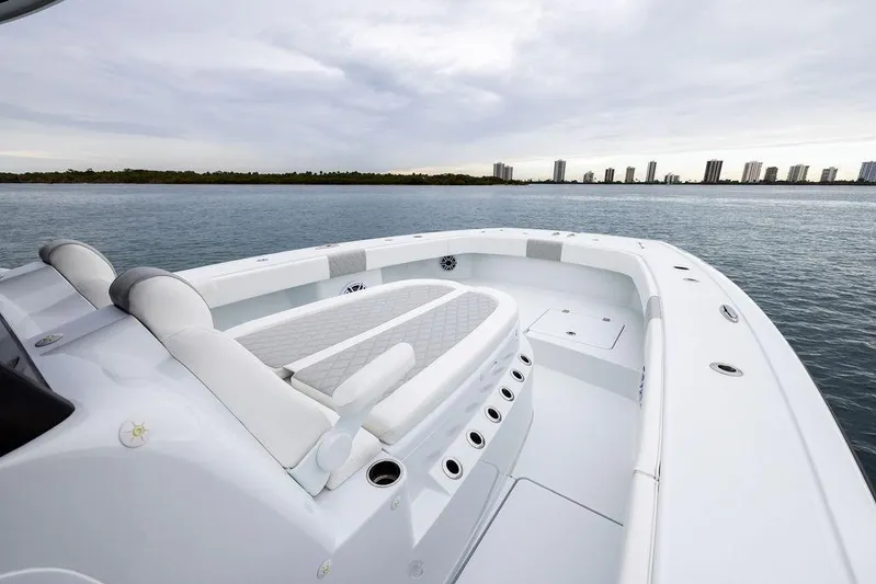 Never Enough Yacht Photos Pics 2025 Freeman 38 boat on calm water with city skyline in background.