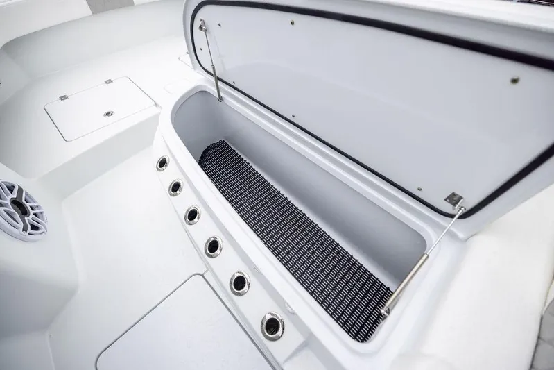 Never Enough Yacht Photos Pics Open storage compartment on 2025 Freeman 38 boat, featuring multiple rod holders and speaker.