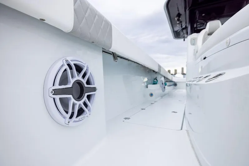 Never Enough Yacht Photos Pics 2025 Freeman 38 boat interior with speaker and cushioned seating.