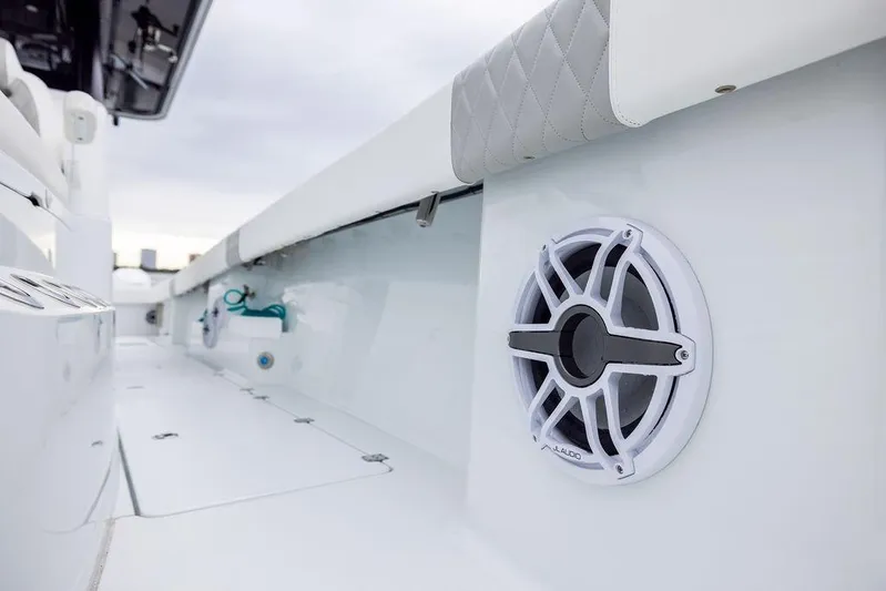 Never Enough Yacht Photos Pics 2025 Freeman 38 boat interior with speaker and cushioned seating detail.