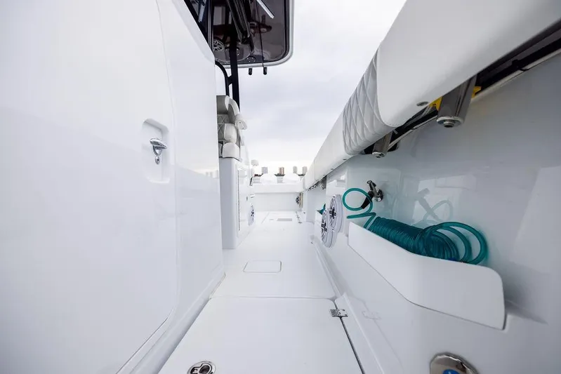 Never Enough Yacht Photos Pics 2025 Freeman 38 boat deck with storage compartments and coiled hose.