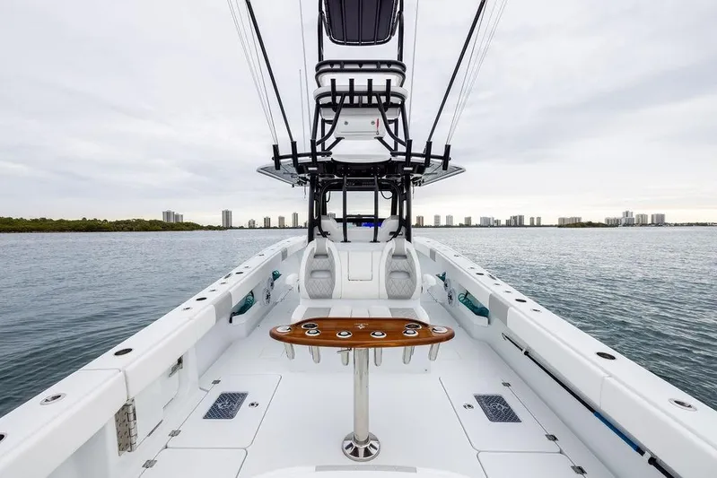 Never Enough Yacht Photos Pics 2025 Freeman 38 boat on water, featuring spacious deck and modern design.