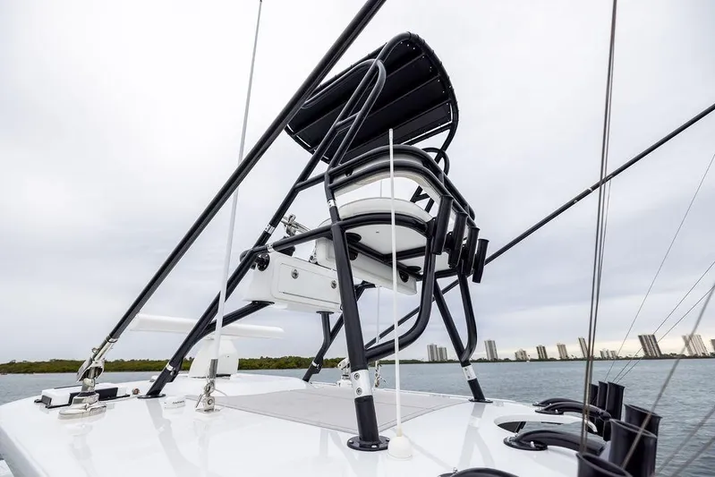 Never Enough Yacht Photos Pics 2025 Freeman 38 boat with elevated seating, sleek design, and city skyline in the background.