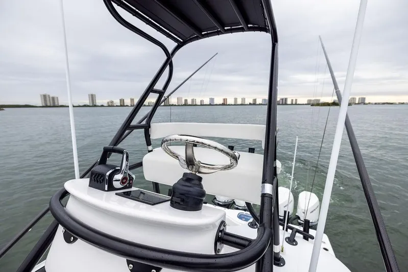 Never Enough Yacht Photos Pics 2025 Freeman 38 boat helm with city skyline in the background.
