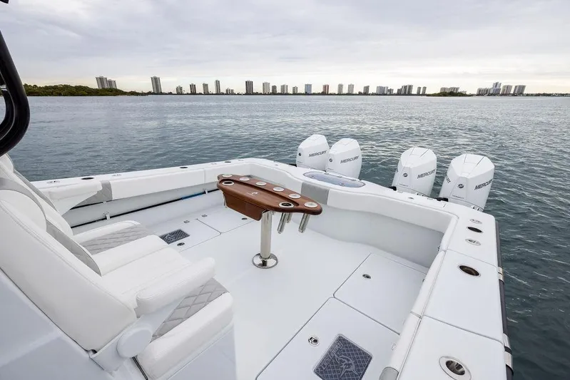 Never Enough Yacht Photos Pics Luxury Freeman 38 boat, 2025 model, with spacious deck and multiple outboard engines on calm water.