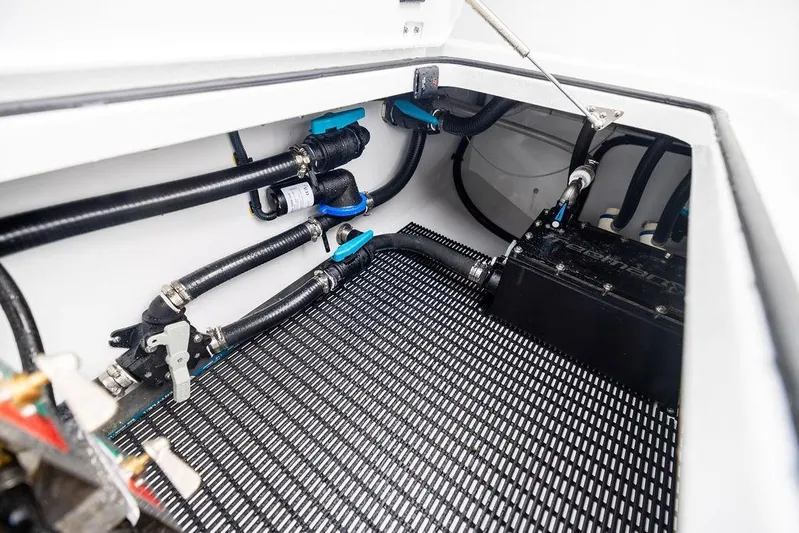 Never Enough Yacht Photos Pics Engine compartment of 2025 Freeman 38 boat with visible hoses and components.