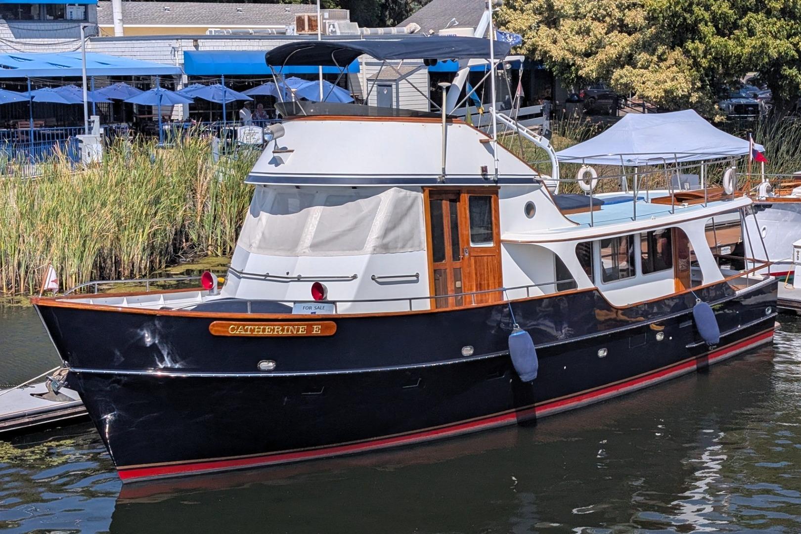 Custom 1989 52 Pilothouse yacht docked, featuring elegant design and wooden accents.