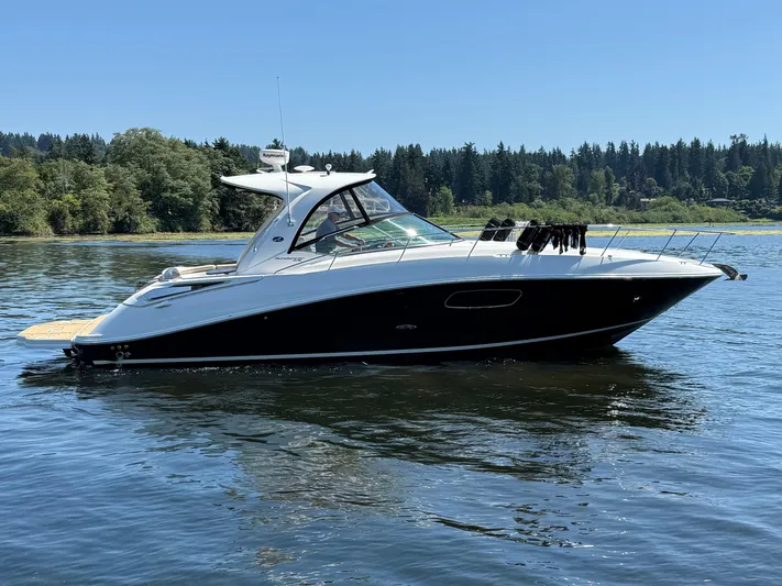  Yacht Photos Pics 2012 Sea Ray 370 Sundancer yacht on a serene lake with forested background.