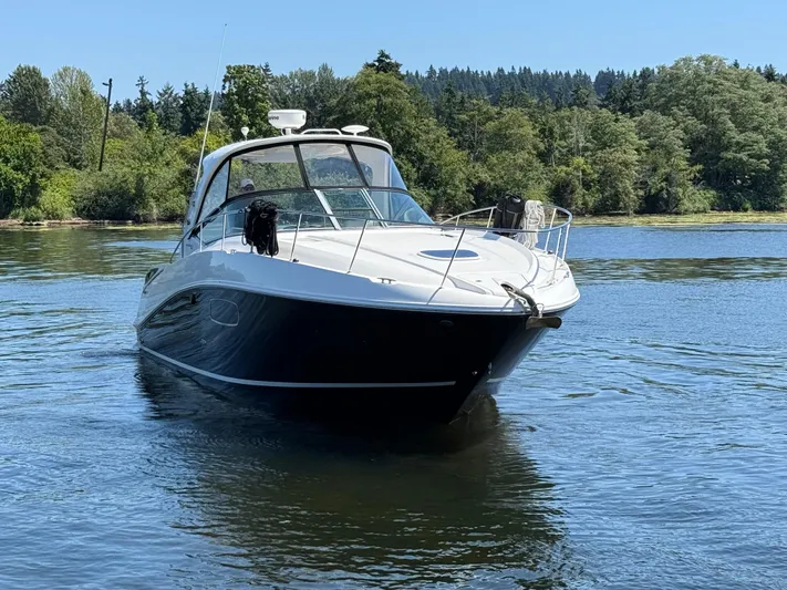  Yacht Photos Pics 2012 Sea Ray 370 Sundancer yacht cruising on a serene lake with lush forest backdrop.