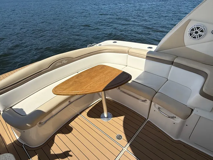  Yacht Photos Pics Luxurious seating area on 2012 Sea Ray 370 Sundancer yacht with wooden table, overlooking water.