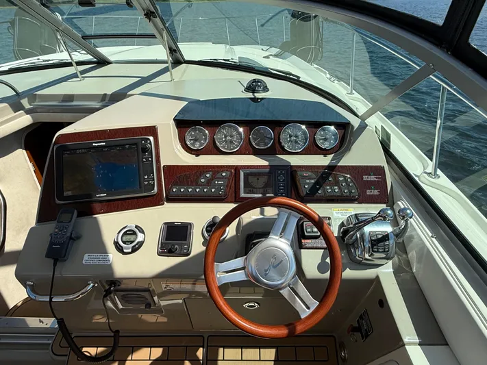  Yacht Photos Pics Cockpit of 2012 Sea Ray 370 Sundancer with steering wheel, navigation system, and control panel.