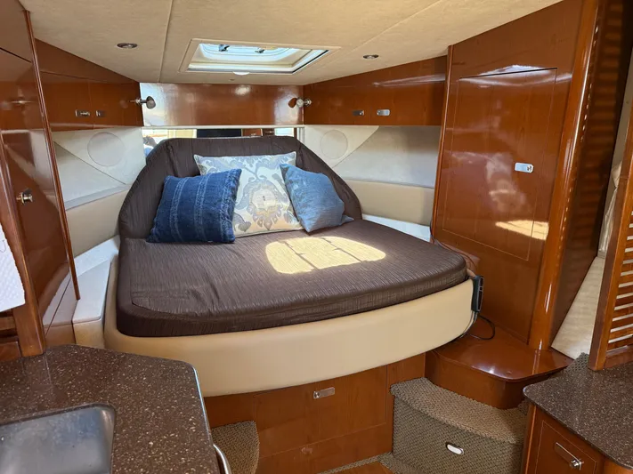  Yacht Photos Pics Luxurious cabin interior of 2012 Sea Ray 370 Sundancer yacht with cozy bed and pillows.
