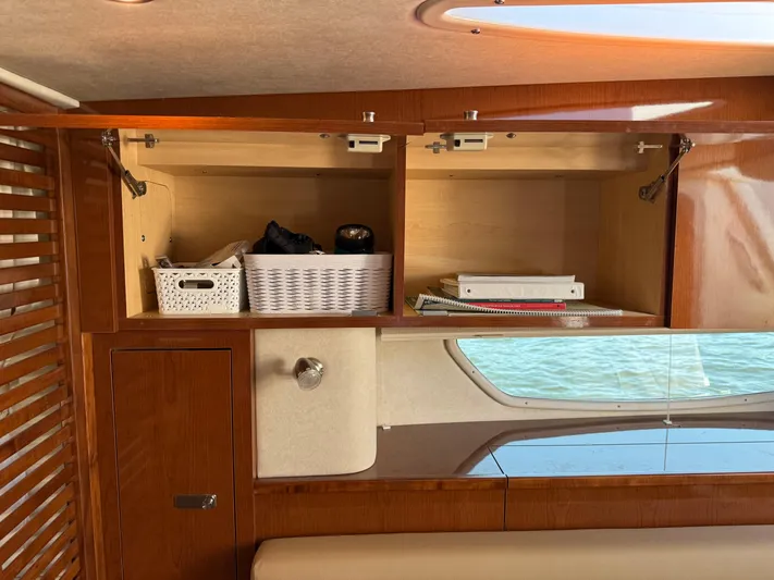  Yacht Photos Pics Interior storage of 2012 Sea Ray 370 Sundancer with wooden cabinets and organized baskets.