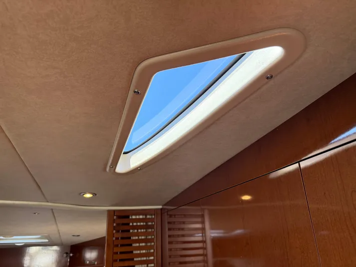  Yacht Photos Pics Interior view of 2012 Sea Ray 370 Sundancer with skylight and wooden paneling.