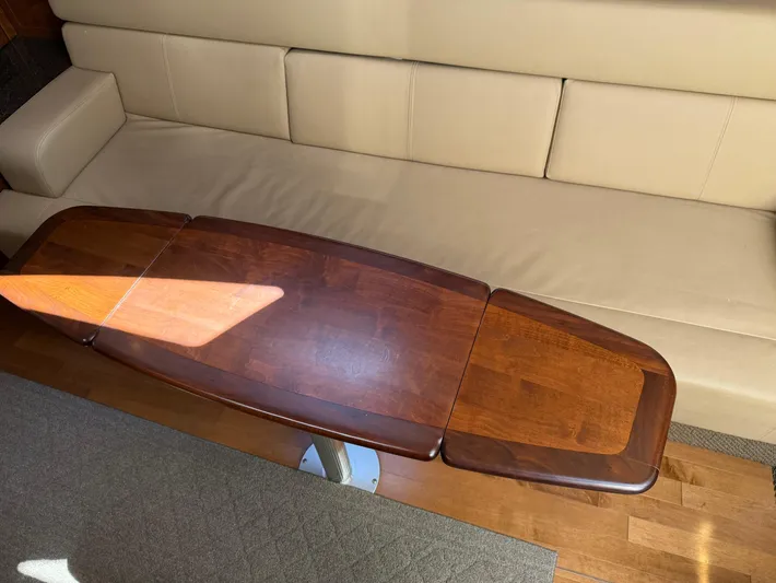  Yacht Photos Pics Interior of 2012 Sea Ray 370 Sundancer with wooden table and beige seating.