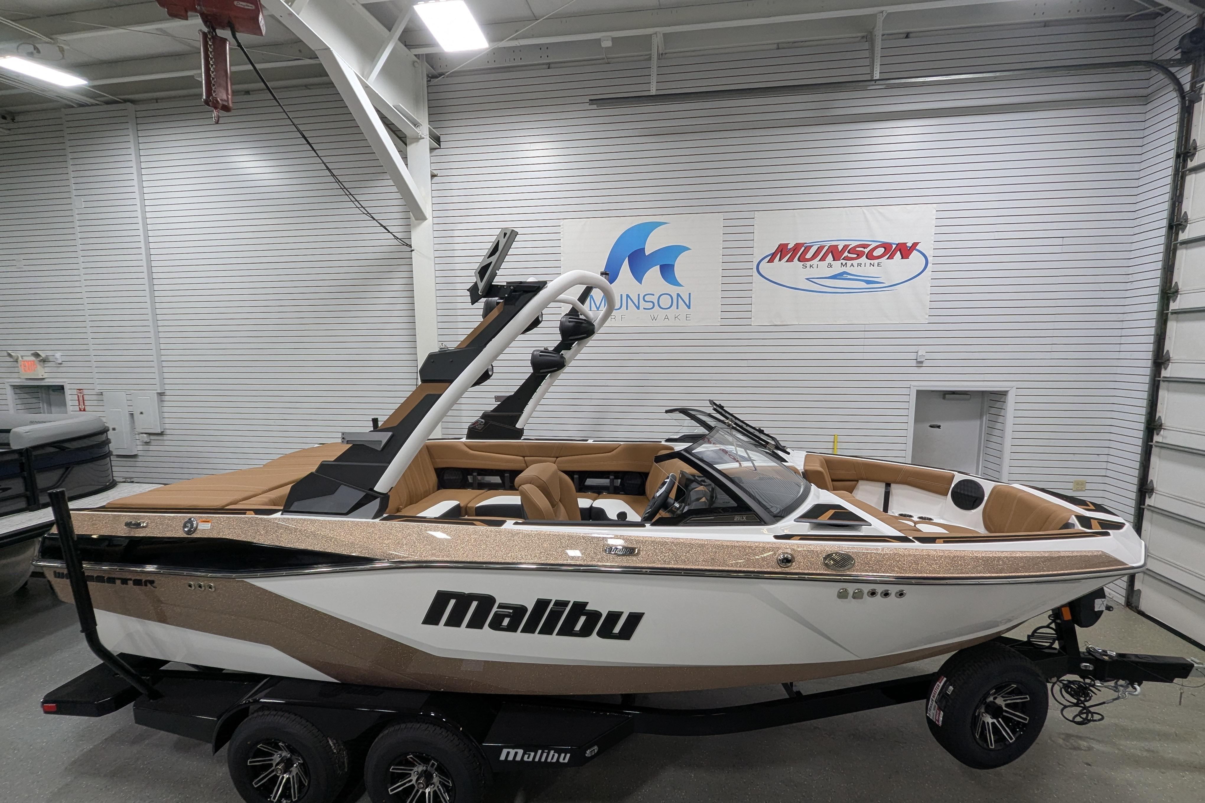 2026 Malibu Wakesetter 21 LX boat in showroom, featuring sleek design and luxury seating.