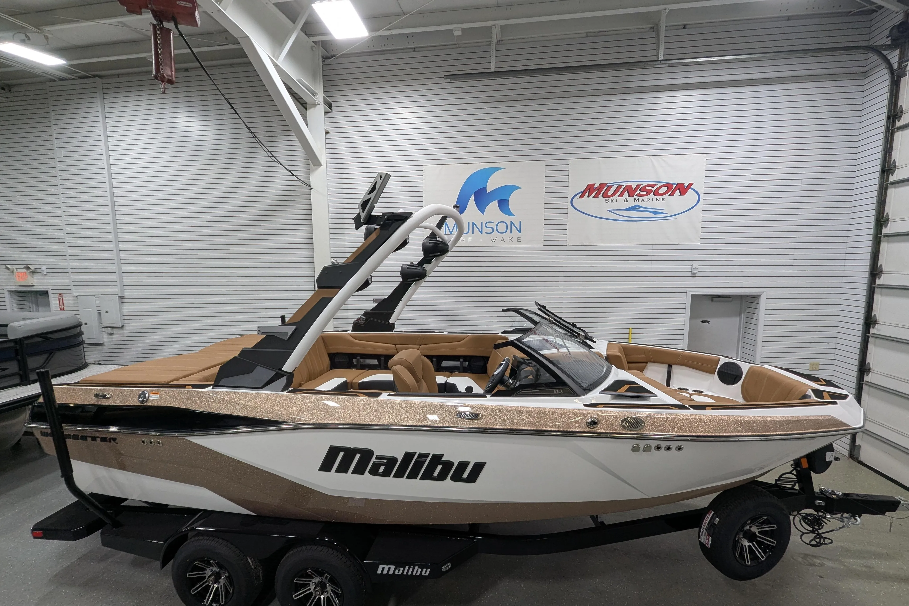 2026 Malibu Wakesetter 21 LX boat in showroom, featuring sleek design and luxury seating.