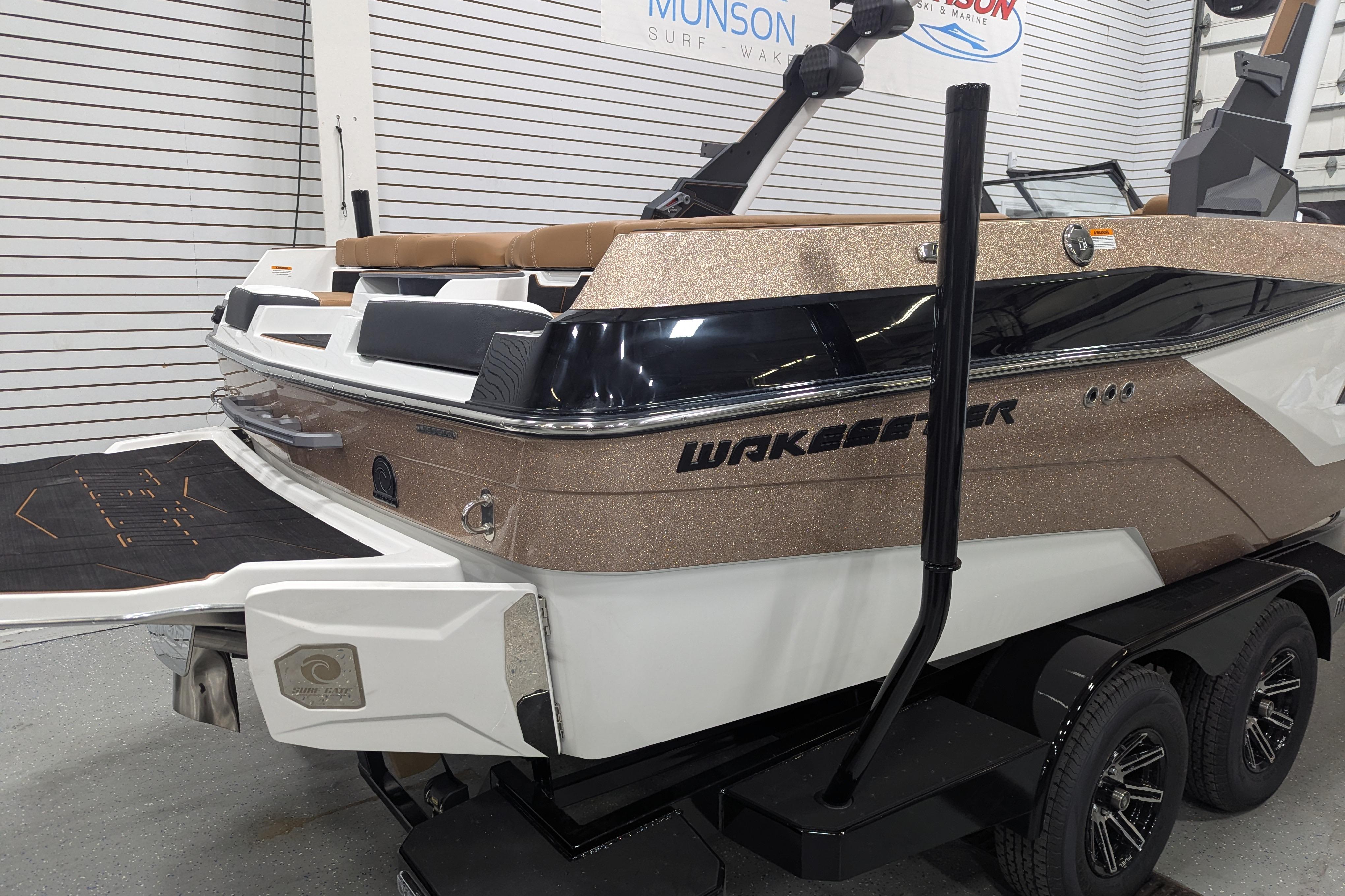 2026 Malibu Wakesetter 21 LX boat in showroom, featuring sleek design and modern features.