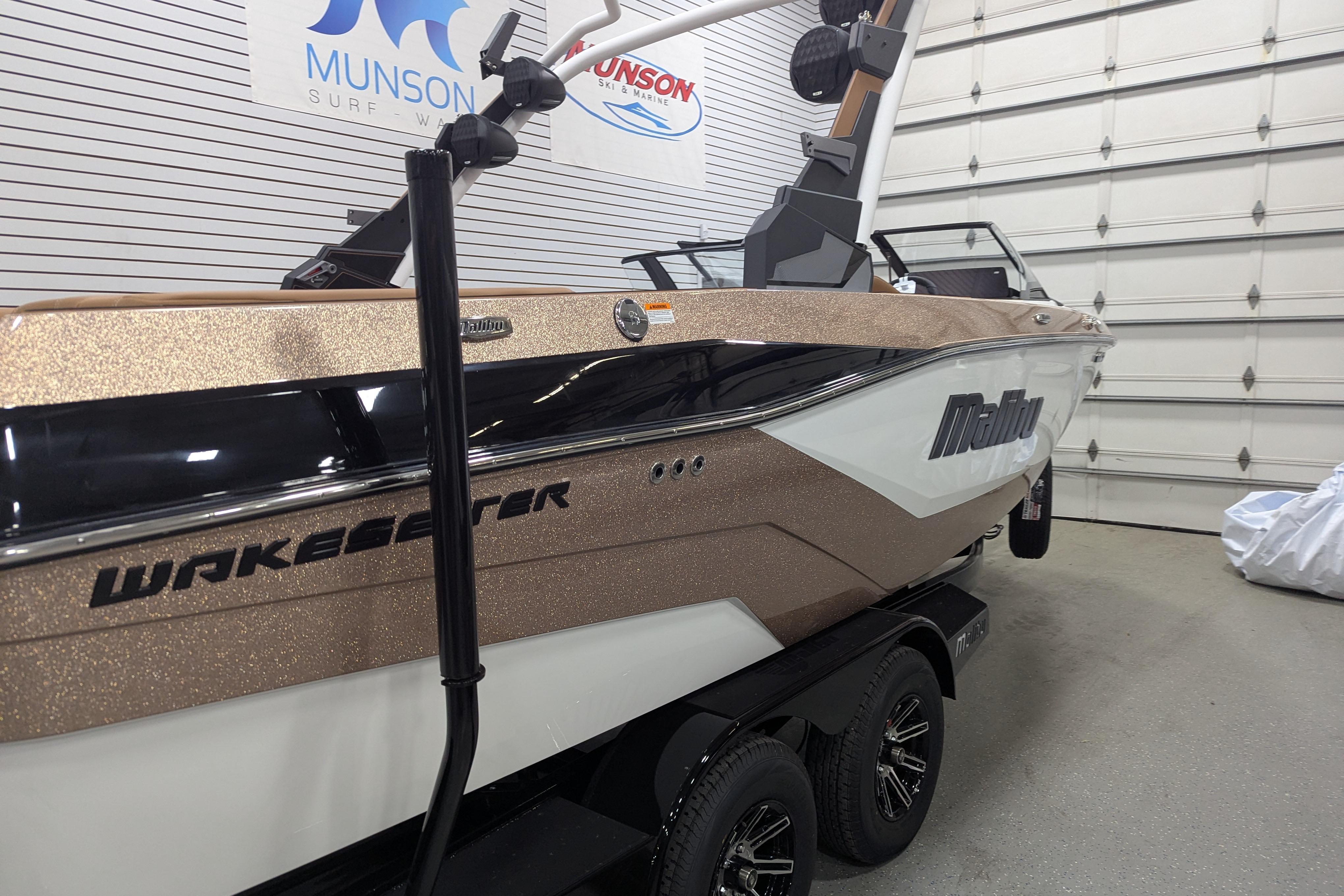 2026 Malibu Wakesetter 21 LX boat in showroom, featuring sleek design and modern features.