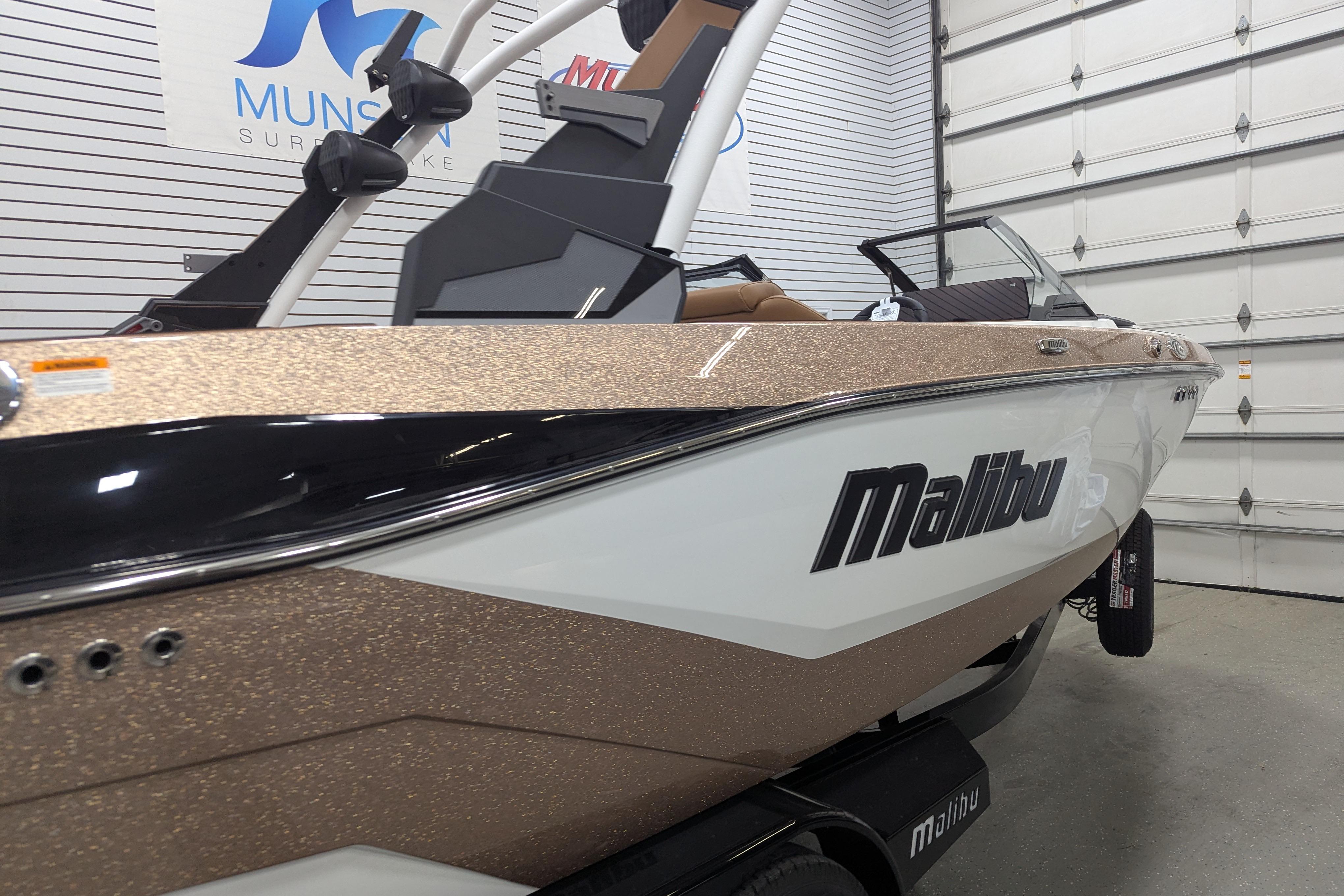 2026 Malibu Wakesetter 21 LX boat in showroom, featuring sleek design and modern finishes.