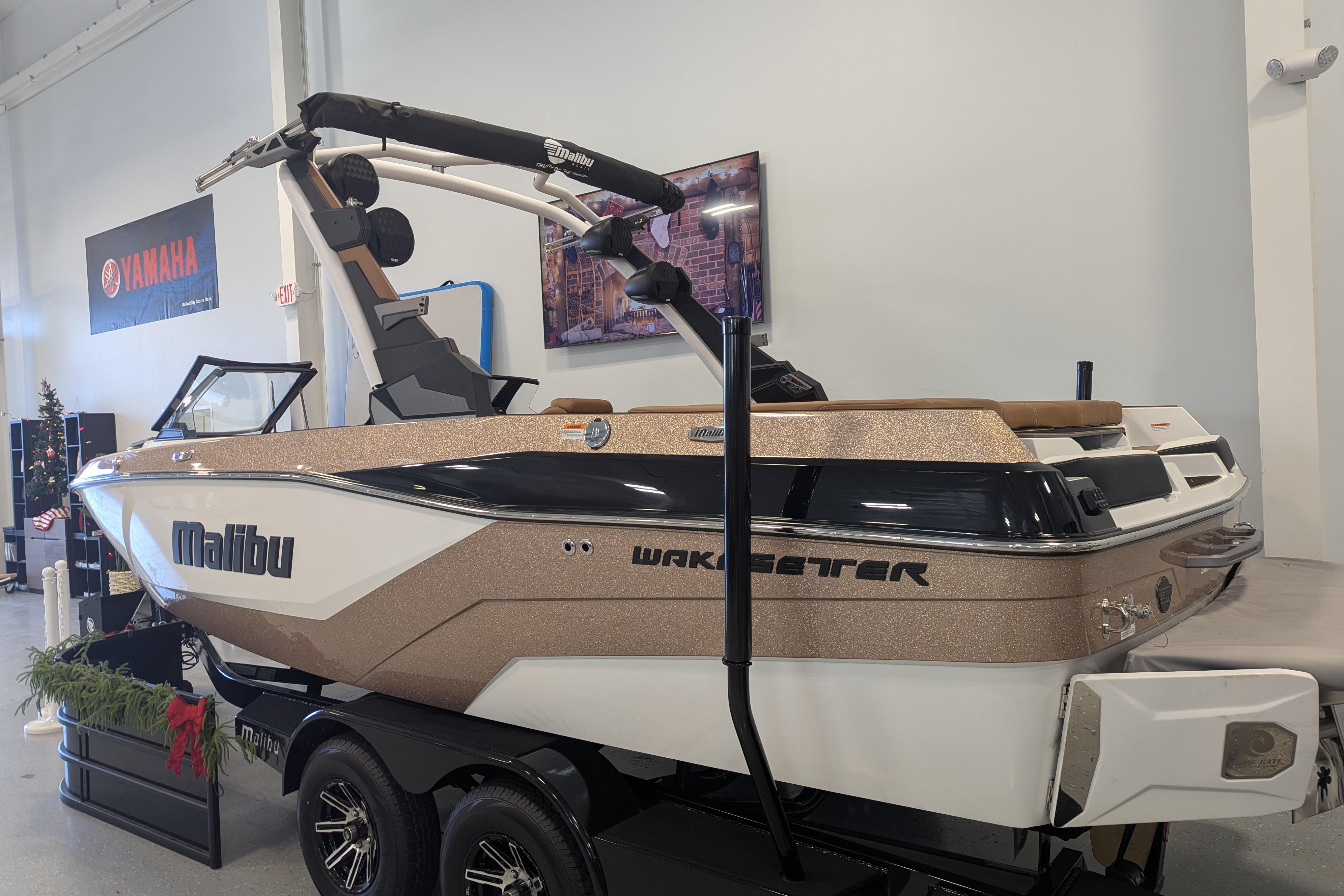 2026 Malibu Wakesetter 21 LX boat displayed indoors, featuring sleek design and modern features.