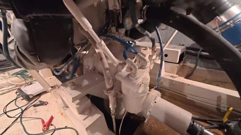 Lochloosa Yacht Photos Pics Engine room of a 1979 Hatteras Sportfish boat, showcasing mechanical components and wiring.