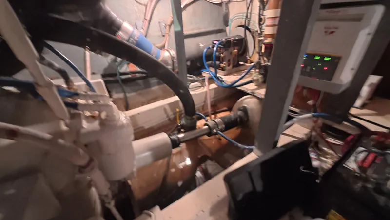 Lochloosa Yacht Photos Pics Engine room of a 1979 Hatteras Sportfish boat, showcasing mechanical components and wiring.
