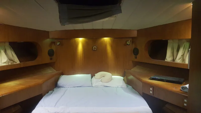 Orly Yacht Photos Pics Cozy cabin interior of a 1990 President 465 yacht with wooden furnishings and ambient lighting.