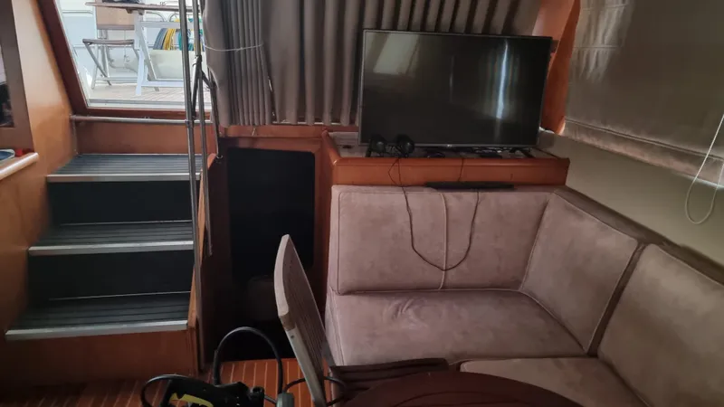 Orly Yacht Photos Pics Cozy yacht interior with stairs, TV, and plush seating, President 465, 1990 model.