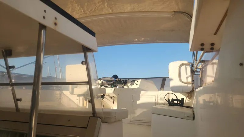 Orly Yacht Photos Pics Interior view of a 1990 President 465 yacht cockpit under a clear blue sky.
