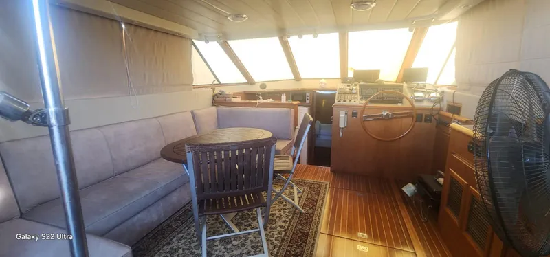 Orly Yacht Photos Pics Luxurious 1990 President 465 yacht interior with seating, table, and helm station.