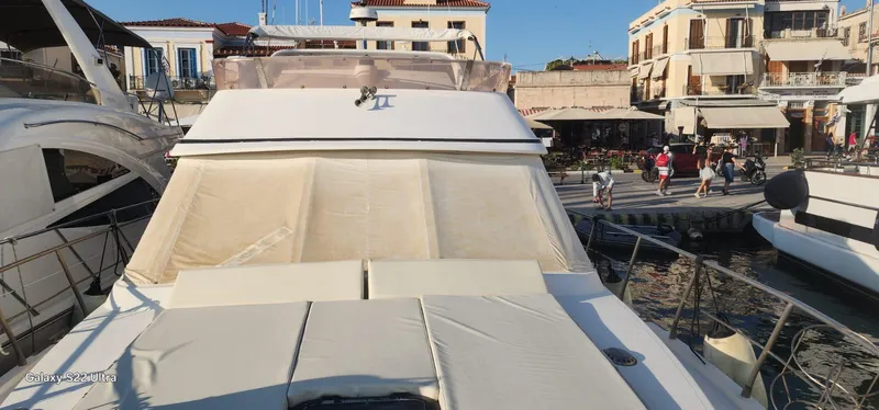 Orly Yacht Photos Pics Luxury yacht docked at marina, President 465 model, 1990, with waterfront buildings in the background.
